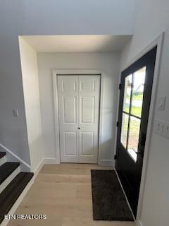 doorway featuring baseboards