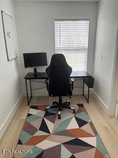 home office with wood finished floors and baseboards