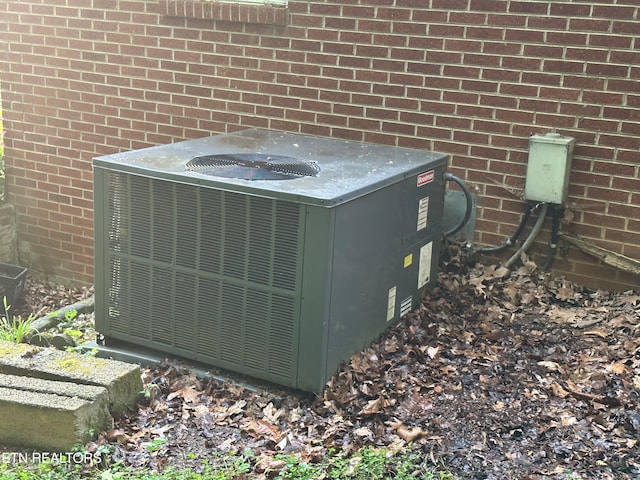 details with central air condition unit and brick siding