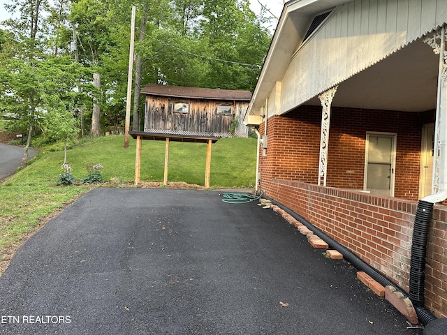 view of home's exterior with a yard and brick siding