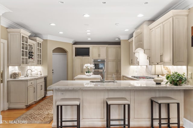 5315 Bent River Blvd, Knoxville, TN 37919 - kitchen with a sink, arched walkways, stainless steel appliances, a peninsula, and ornamental molding