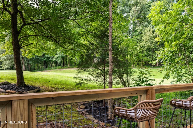 wooden deck with a lawn