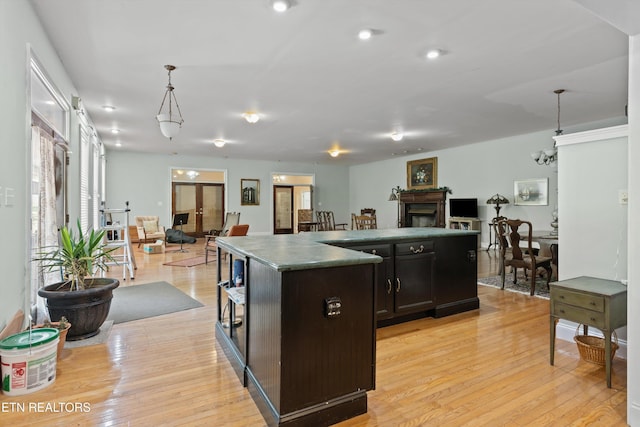 702 Meadowview Dr, Harriman, TN 37748 - kitchen featuring a fireplace, open floor plan, light wood-style flooring, and a center island