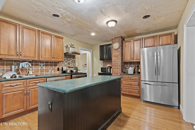 702 Meadowview Dr, Harriman, TN 37748 - kitchen featuring decorative backsplash, dark countertops, appliances with stainless steel finishes, wall chimney exhaust hood, and light wood-style flooring