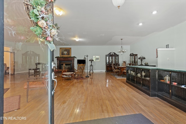 702 Meadowview Dr, Harriman, TN 37748 - living area featuring a notable chandelier, a fireplace, wood-type flooring, recessed lighting, and baseboards