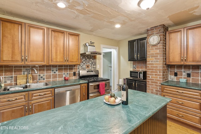 702 Meadowview Dr, Harriman, TN 37748 - kitchen featuring brown cabinetry, dark countertops, wall chimney exhaust hood, a sink, and appliances with stainless steel finishes