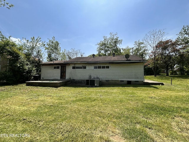 rear view of house with a yard, crawl space, and cooling unit