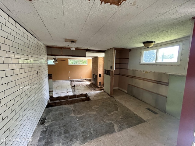 below grade area featuring ceiling fan and visible vents