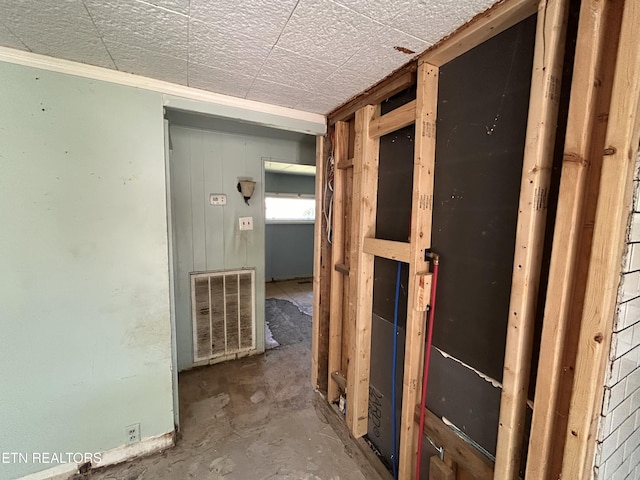 hallway featuring crown molding and visible vents