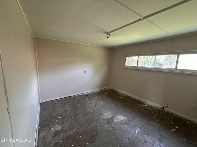 spare room featuring baseboards
