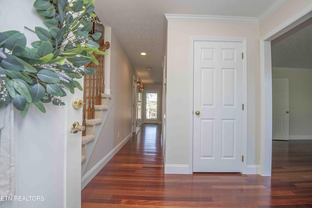 hall with baseboards, recessed lighting, crown molding, and wood finished floors