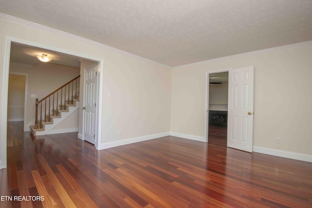 empty room with baseboards, stairs, and hardwood / wood-style floors