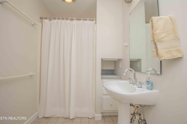 full bathroom with baseboards, tile patterned floors, and a shower with curtain