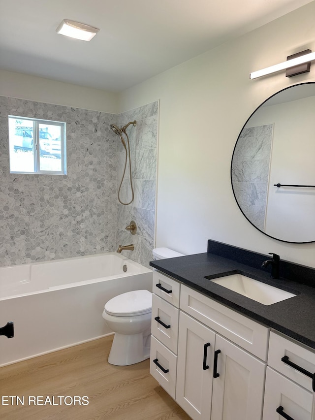 full bathroom featuring vanity, toilet, wood finished floors, and shower / bathing tub combination