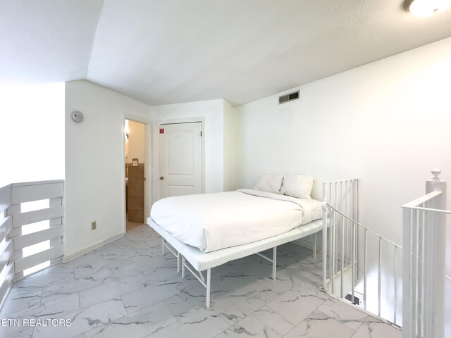 bedroom featuring visible vents and marble finish floor
