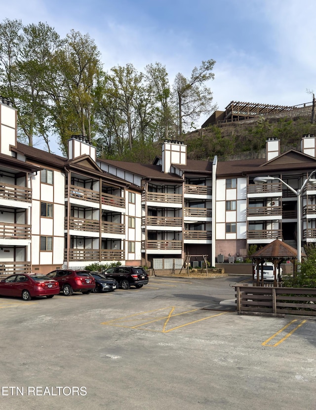 view of property with uncovered parking