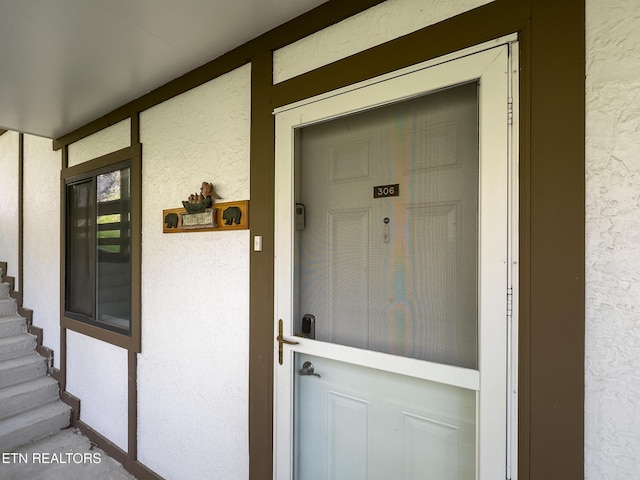 view of exterior entry with stucco siding