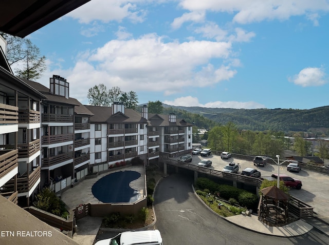 exterior space featuring a mountain view and uncovered parking