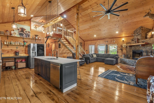 487 Fish Hatchery Rd, Sweetwater, TN 37874 - kitchen featuring appliances with stainless steel finishes, a sink, wood ceiling, wooden walls, and light wood-type flooring