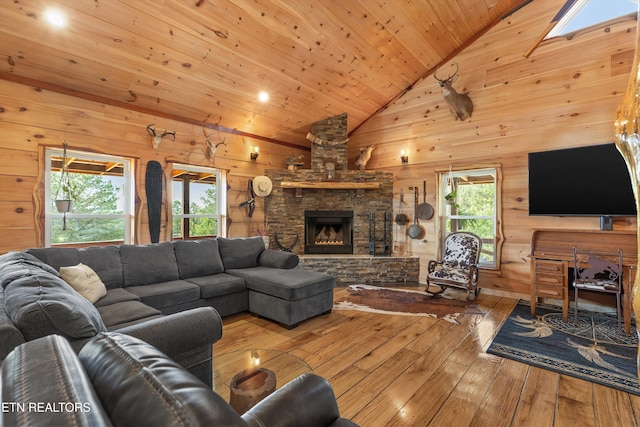 487 Fish Hatchery Rd, Sweetwater, TN 37874 - living area featuring hardwood / wood-style floors, wood walls, wooden ceiling, a stone fireplace, and high vaulted ceiling