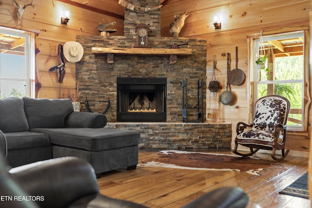 487 Fish Hatchery Rd, Sweetwater, TN 37874 - living room with wooden walls, hardwood / wood-style floors, and a stone fireplace
