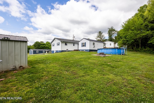 172 W Hills Rd, Rutledge, TN 37861 - back of property with a lawn, a storage shed, an outdoor structure, and an outdoor pool