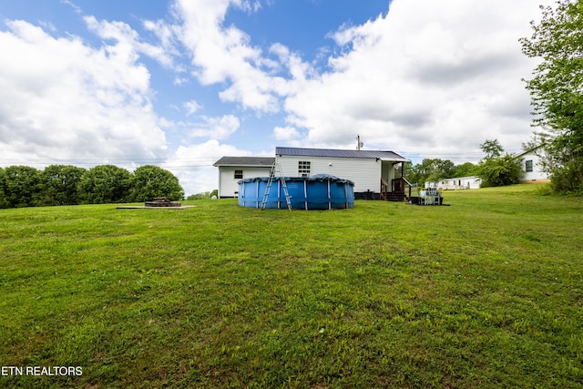 172 W Hills Rd, Rutledge, TN 37861 - back of house featuring a covered pool, a lawn, and metal roof