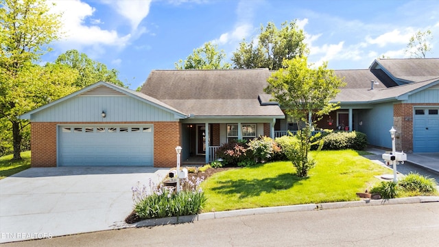 ranch-style house featuring covered porch, a front yard, brick siding, concrete driveway, and an attached garage