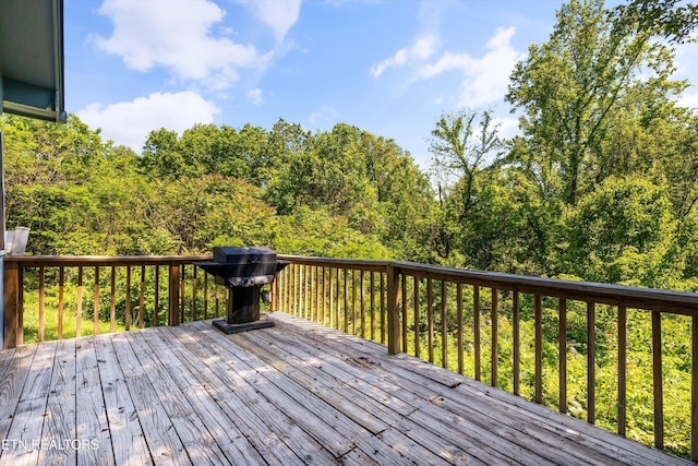 wooden terrace with a wooded view