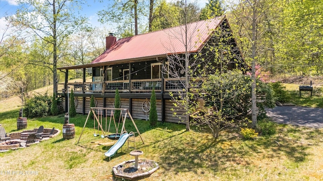view of outbuilding featuring a playground and an outdoor fire pit