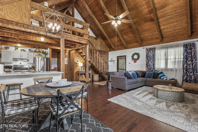 dining area with dark wood-style flooring, wood walls, stairway, wooden ceiling, and high vaulted ceiling