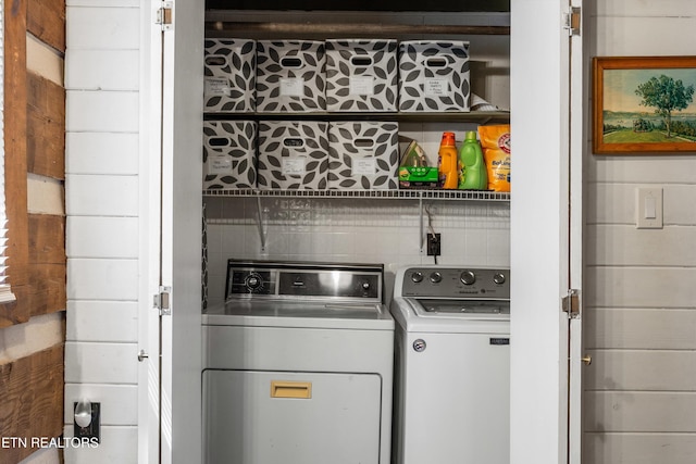 clothes washing area with laundry area and washer and clothes dryer