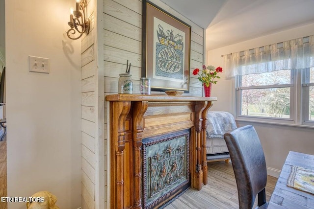 home office with baseboards and wood finished floors