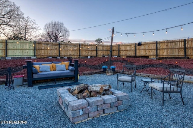 view of patio with a fenced backyard and a fire pit
