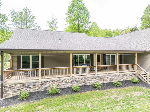rear view of house with a shingled roof