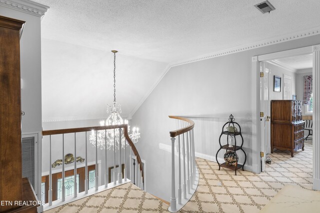 145 Lynn Ave, Jellico, TN 37762 - hall with visible vents, lofted ceiling, a textured ceiling, a chandelier, and an upstairs landing