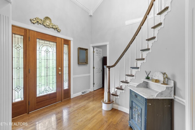 145 Lynn Ave, Jellico, TN 37762 - foyer featuring visible vents, stairway, baseboards, light wood-style floors, and ornamental molding
