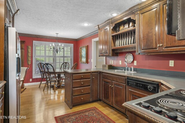 145 Lynn Ave, Jellico, TN 37762 - kitchen with a notable chandelier, a sink, light wood-style floors, freestanding refrigerator, and a peninsula