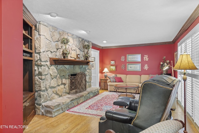 145 Lynn Ave, Jellico, TN 37762 - living area featuring ornamental molding, a stone fireplace, and wood finished floors