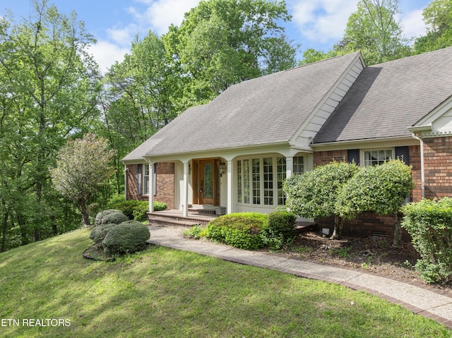 145 Lynn Ave, Jellico, TN 37762 - ranch-style home featuring brick siding, a shingled roof, and a front yard
