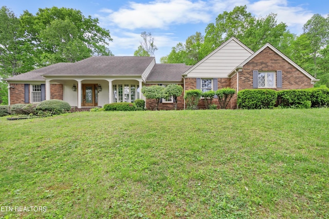 145 Lynn Ave, Jellico, TN 37762 - ranch-style house with brick siding, a front yard, and a porch