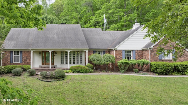 145 Lynn Ave, Jellico, TN 37762 - view of front of property featuring a shingled roof, a front lawn, brick siding, a porch, and a chimney