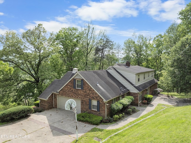145 Lynn Ave, Jellico, TN 37762 - view of front of property featuring brick siding, driveway, a chimney, and a front yard