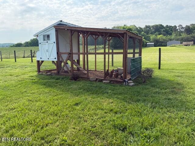 view of poultry coop featuring a lawn