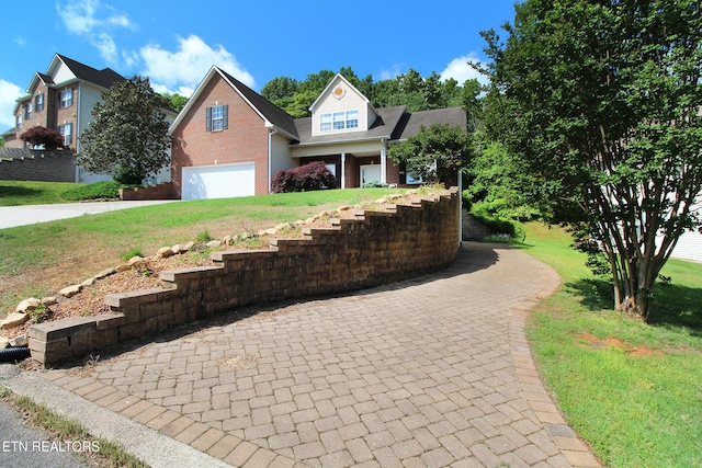 13177 Clear Ridge Rd, Knoxville, TN 37922 - view of front facade with a garage, driveway, brick siding, and a front yard