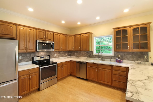 13177 Clear Ridge Rd, Knoxville, TN 37922 - kitchen with appliances with stainless steel finishes, a sink, brown cabinets, glass insert cabinets, and crown molding