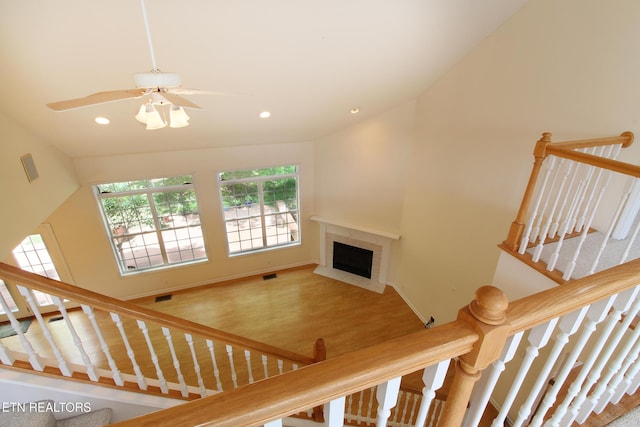 13177 Clear Ridge Rd, Knoxville, TN 37922 - stairs with recessed lighting, a tile fireplace, a ceiling fan, wood finished floors, and vaulted ceiling