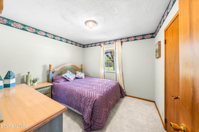 bedroom with baseboards, carpet flooring, and a textured ceiling
