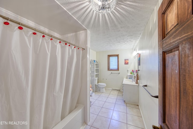 bathroom with tile patterned floors, baseboards, vanity, toilet, and a chandelier