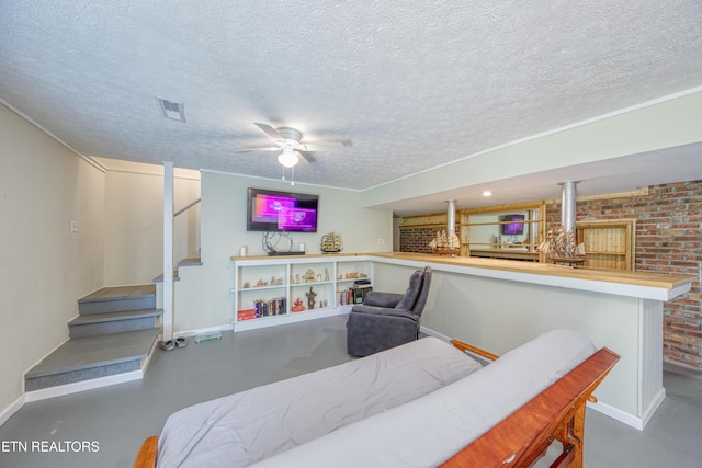 bedroom featuring baseboards, a textured ceiling, concrete floors, and visible vents